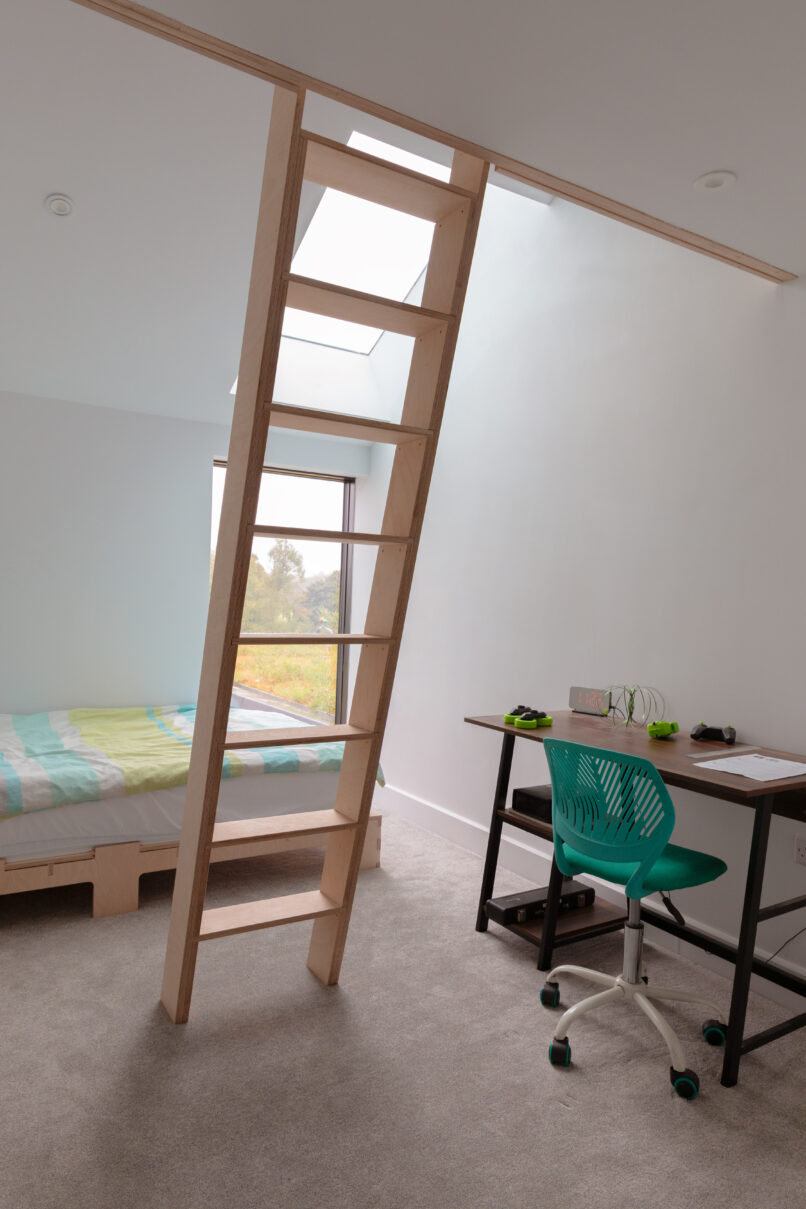 Bedrooms make use of the the tall spaces with mezzanines used for storage